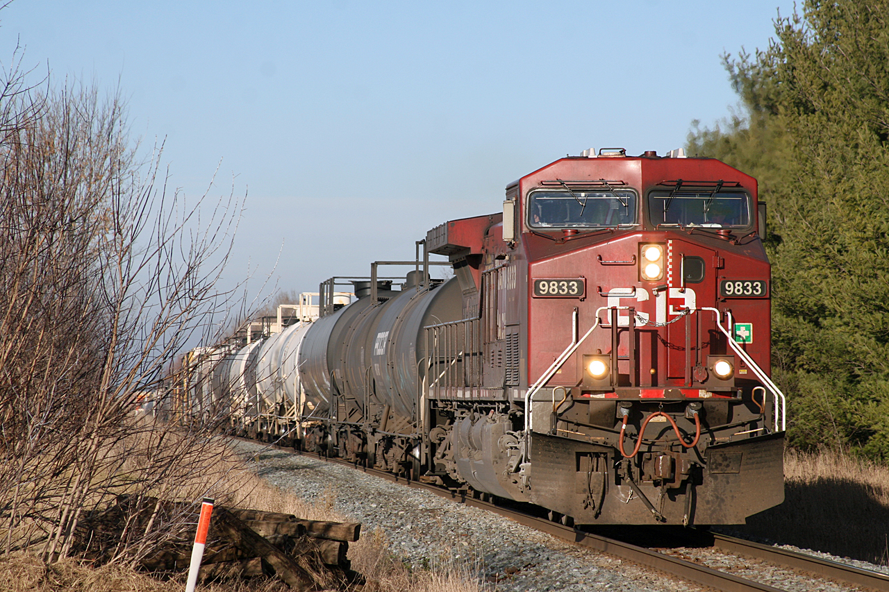 After hearing CP 9833 call clear to Baxter, I made a quick detour up Line 5 to the tracks; arriving just in time!  CP 9833 leads train 118-03 through the farmland just outside of Alliston.  CP 9727 is out of sight, mixed in amongst the 69 loads and 3 empties that make up train 118.  These two AC44's will have no issue keeping this 8191 ton, 6561 foot long train rolling along at trackspeed.