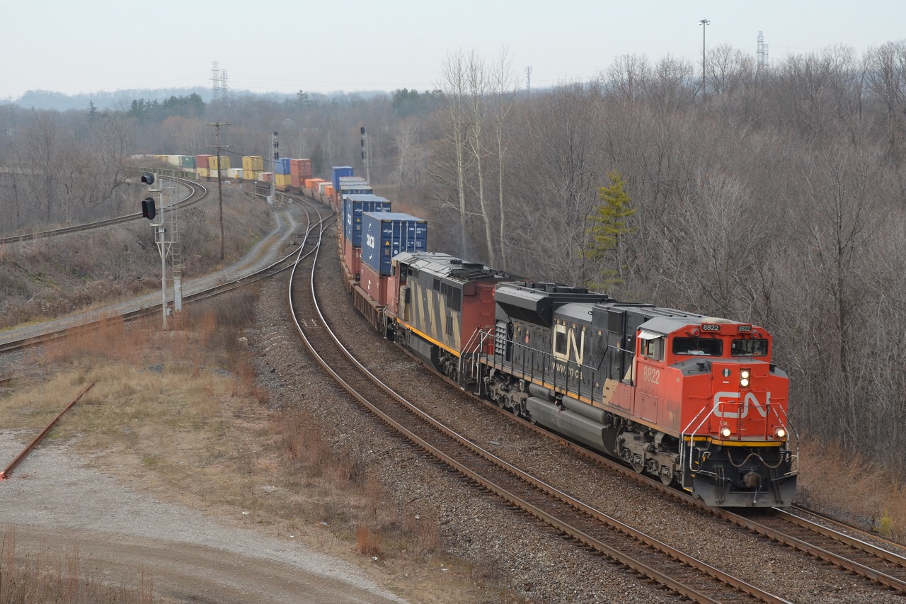 During the first break of sun on a hazy afternoon, CN Q148 with containers for Montreal heads for BIT.