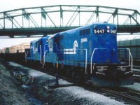 Seen on Fort Erie trackage now long removed, Conrail GPs 5447 and 5448; both fresh from a rebuild program that ran from 1976-1979 either by ICG, ROCK or MK; haul a long string of container laden gons off the old Dunnville Sub trackage heading toward the USA. Overhead is the Central Ave roadbridge. Some minor changes resulted in these units being reclassified as GP8 rather than the GP7s as originally built. Would be nice if some experienced railroader with this group could verify what sort of merchandise was shipped via this Fort Erie "Container Train". I have always been curious.
 