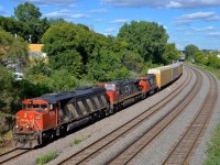 <b>A nice elephant style lashup.</b> Zebra-striped CN 5510 leads CN 401 through Montreal West. Trailing elephant style are CN 2554 and CN 9639. 