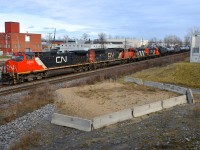 <b>Local power for Brockville trailing.</b> CN 373 is passing through Dorval with two GP9's trailing the road power. Those two units (CN 4129 & CN 7083) entered Montreal on CN 586 and are heading back to Brockville. Ahead are CN 2593 & CN 5768. At right is part of an overpass that has been sitting there for about 5 years without it being completed due to the government failing to get permission from CN and CP to build on or over there tracks here before they began work.