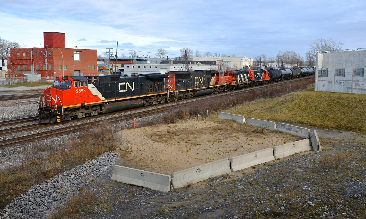 Local power for Brockville trailing. CN 373 is passing through Dorval with two GP9's trailing the road power. Those two units (CN 4129 & CN 7083) entered Montreal on CN 586 and are heading back to Brockville. Ahead are CN 2593 & CN 5768. At right is part of an overpass that has been sitting there for about 5 years without it being completed due to the government failing to get permission from CN and CP to build on or over there tracks here before they began work.