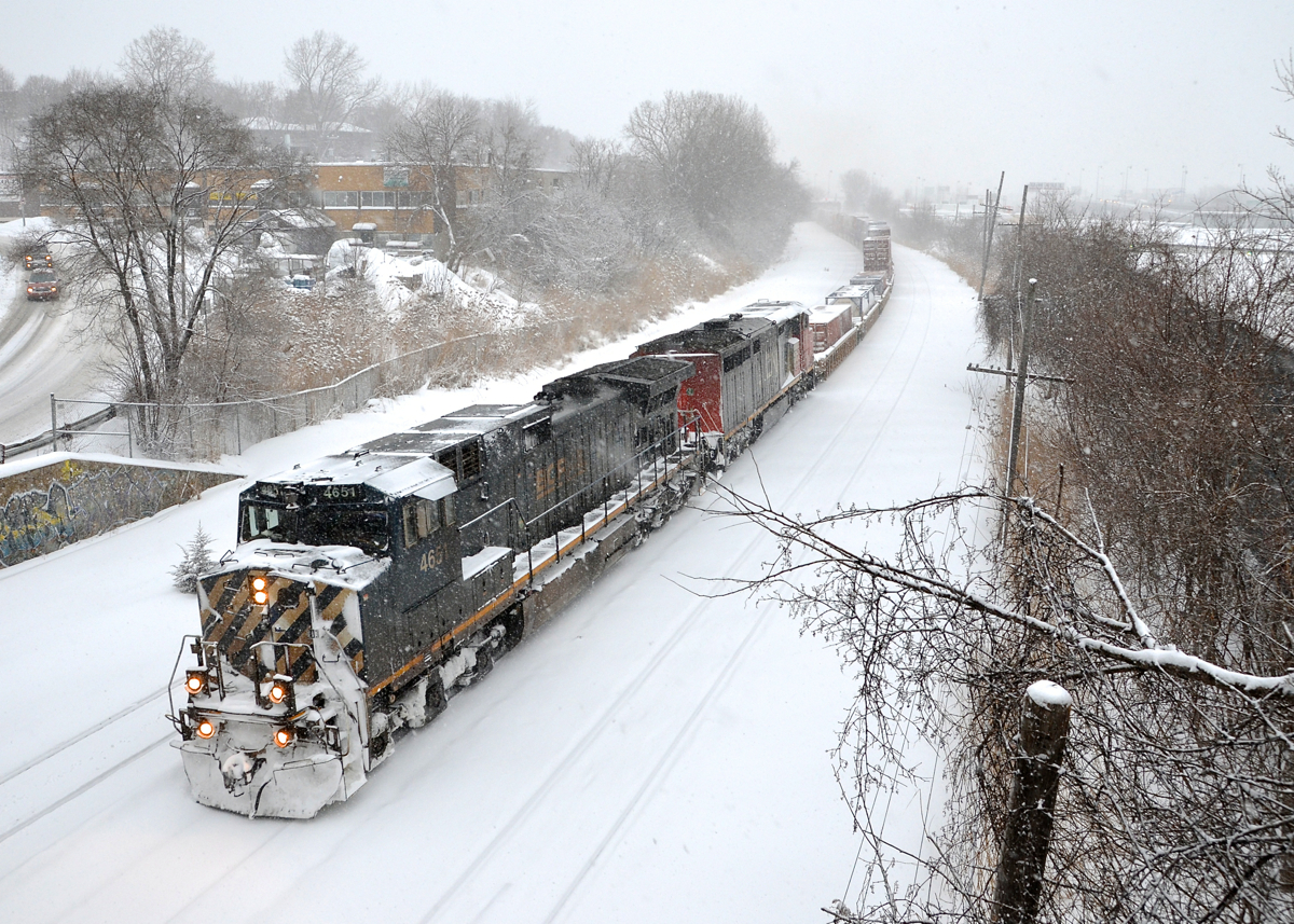 CN 149 in a snowstorm. BCOL 4651 & CN 2449 head west with CN 149 after doing a lift at Turcot West during a snowstorm in February 2014.