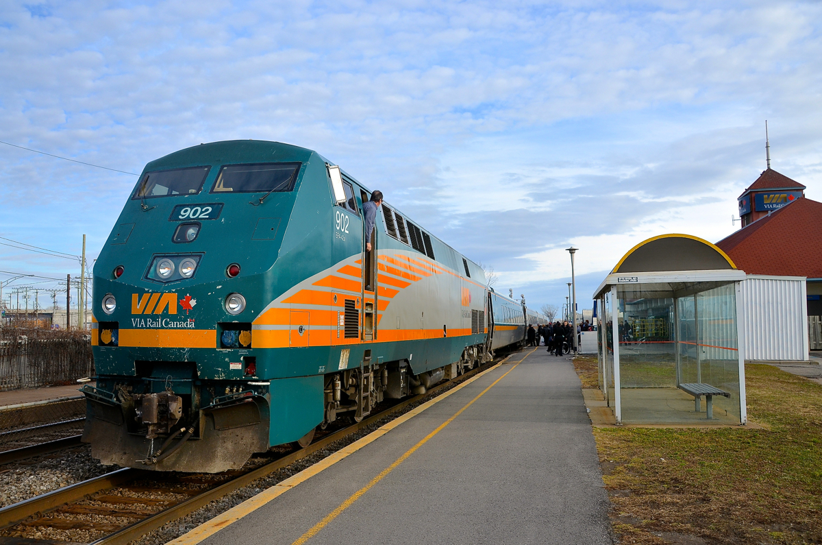 Looking out at a busy station scene. A crewmember is looking out of the lead engine of VIA 55 and witnessing a very busy boarding of Christmas day passengers at Dorval station. Soon the train will depart for Toronto, by way of Ottawa.