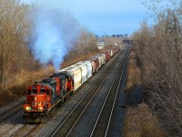 <b>Smoke show!</b> Montreal-area transfer CN 500 smokes it up while approaching Taschereau Yard with 30 cars. Power is GP9 CN 7062 & GP38-2 CN 4732.