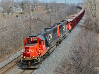 A pair of ex-Oakway SD60's (CN 5442 and CN 5468) heads west through Beaconsfield with a loaded ballast train. 