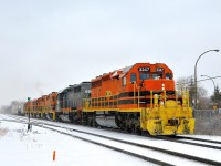 <b>Lots of orange power on a snowy day (finally).</b> During Montreal's first significant snowfall this winter, a very long Quebec Gatineau transfer from CP's St-Luc Yard to QG's Sainte-Thérèse Yard is eastbound on CP's Adirondack sub with 6 units and 7,100 feet of train. Full lashup is QG 3347, QG 6904, QG 2300, QG 2501, QG 801 & QG 3801.