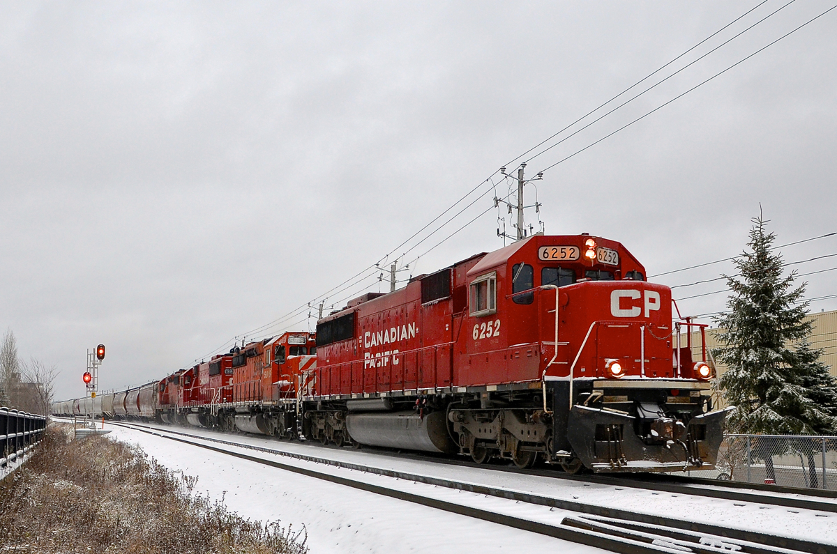 With All-EMD on a loaded grain train. With 103 loaded grain hoppers, a Quebec Gatineau train with 4 CP EMD's (CP 6252, CP 5919, CP 6239 & an unknown SD40-2) heads east on CP's Park sub, approaching the AMT station of Chabanel