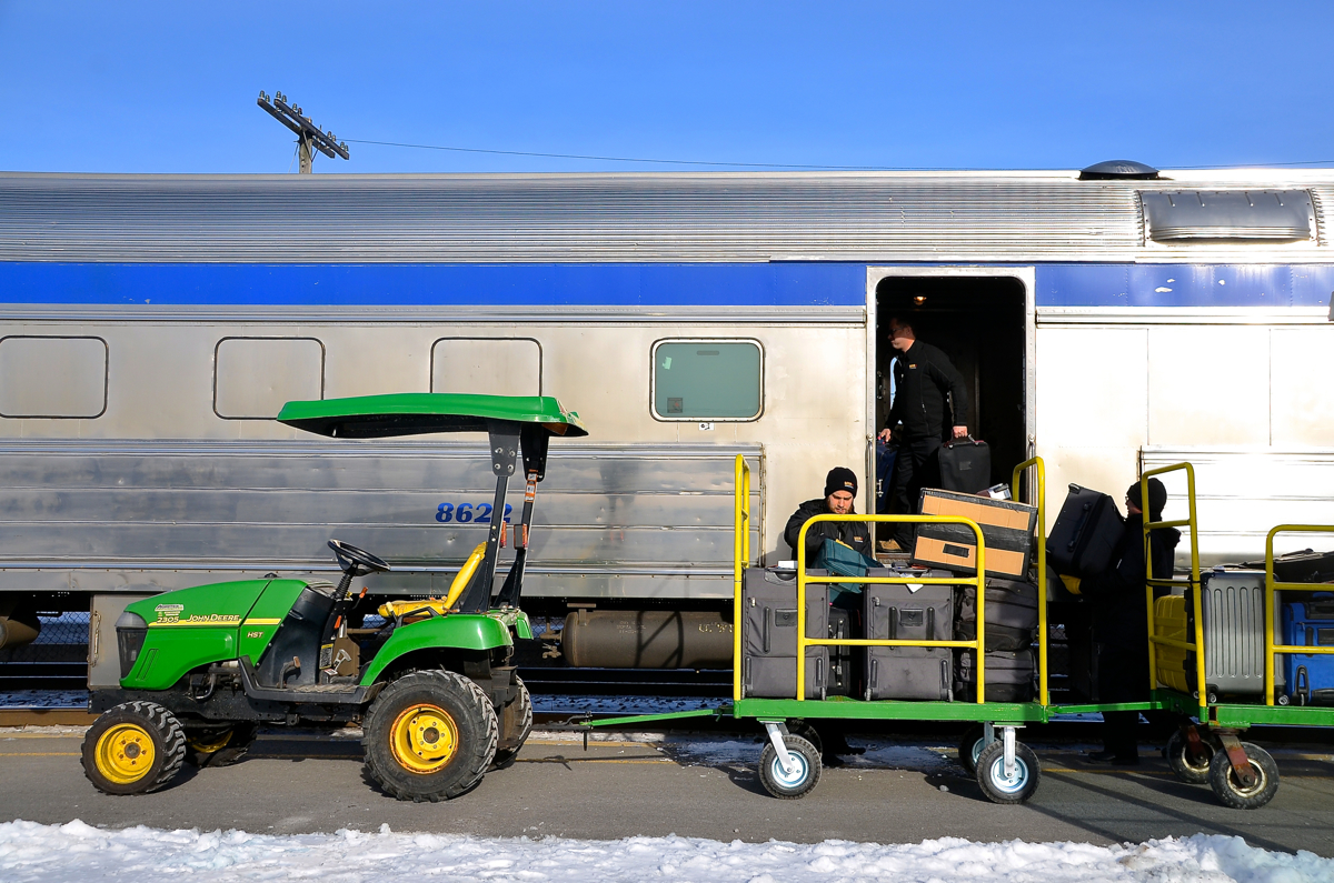 Loading the baggage car. Most VIA trains on the Windsor-Quebec City corridor do not feature checked baggage, but select trains do. Here baggage is loaded one of these trains (VIA 63) at Dorval.