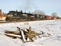 <b>Passing old ties on the old right of way.</b> NS 9323, NS 6908 & NS 8913 lead CN 529 through the new right of way on CN's Montreal sub near the de Courcelle crossing just a bit before noon. At right are ties from the old right of way. Infrastructure projects in the Turcot area have made it necessary for CN to move their main line a bit further north. 