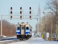 <b>New signal bridge, operating on a new track.</b> AMT 85 is approaching Montreal West station with cab car AMT 705 leading on a cold afternoon. It is passing a signal bridge that was installed only a month ago or so and is operating on a track that was put into service only a couple of weeks ago.