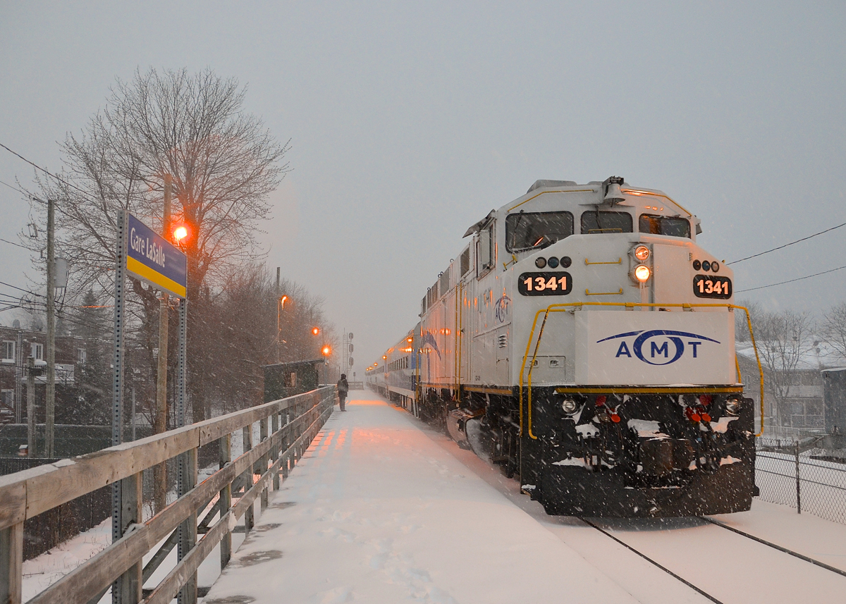 White unit in the snow. AMT 84 with white ex-GO Transit AMT 1341 leading is arriving at Lasalle station as the snow falls.