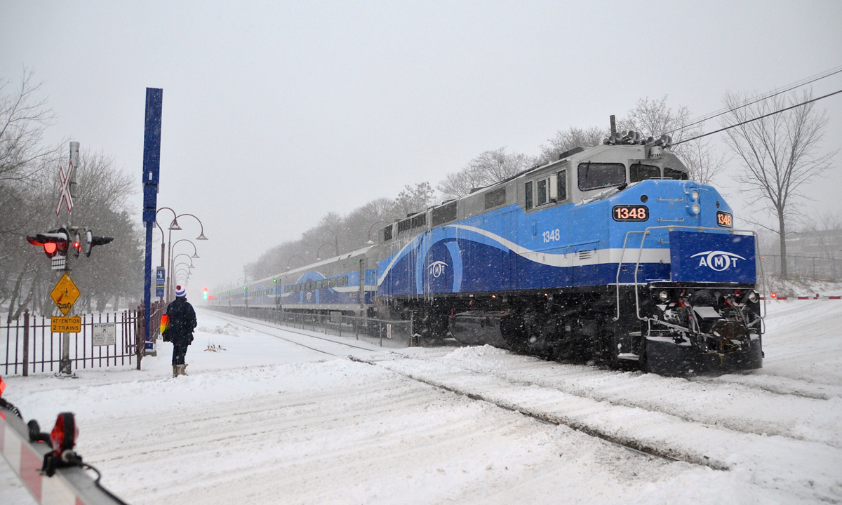 First big snowstorm of winter. AMT 1348 (rebuilt and repainted by Brookville recently) is pushing a deadhead train towards Montreal West Station on the day Montreal got its first big snowstorm.