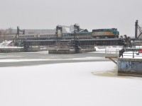 <b>A bit more snow.</b> VIA 62 is crossing the Lachine Canal on its way to Montreal's Central Station as a bit more snow falls. In the foreground is the ice and snow covered Peel Basin.