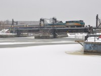 <b>A bit more snow.</b> VIA 62 is crossing the Lachine Canal on its way to Montreal's Central Station as a bit more snow falls. In the foreground is the ice and snow covered Peel Basin.