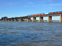 <b>CP 253 crossing the St-Lawrence river.</b> CP 8820 & CP 9804 lead CN 253 over the St-Lawrence river after waiting for the Seaway bridge to go back down after a boat passed. The Seaway bridge is visible in the distance at left.