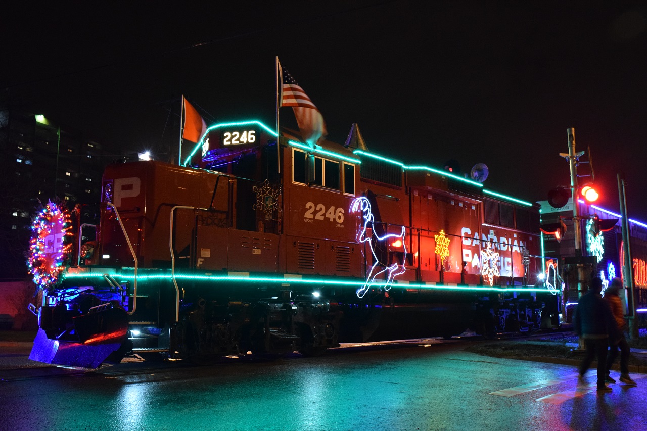 The Canadian Pacific Holiday train is stopped at St. George Street in London, ON. This years power is 2246 (a GP20c-ECO). The previous rain provided a nice reflection of the lights on the road.