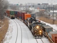 <b>A busy intermodal morning.</b> Both CN 149 and CN 148 are switching at Turcot West, which is quite unusual as CN 148 usually is through Montreal during the middle of the night and terminates before CN 149 originates. Here we have CN 149 departing on the freight track with BCOL 4645 & BCOL 4608 after picking up cars. At right on the north track is most of CN 148's train (which will leave for the port of Montreal in not too long) while on the transfer track a cut of cars from CN 148 have been dropped.