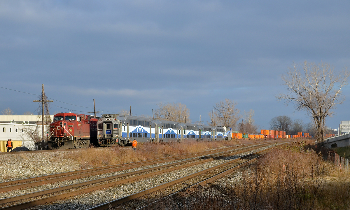 Out for the inspection. The crew of CP 143 (with CP 9770 leading) is out to inspect AMT 53 which is heading west through Dorval led by cab car AMT 3015. As soon as AMT 53 passes CP 143 will follow it westwards.