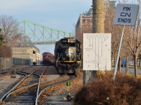 <b>A delay in leaving the port.</b> CN 149 will have to wait longer than usual to leave the Port of Montreal due to a broken rail ahead on the CN Wharf Spur. In the mean time it sits on Port of Montreal trackage with leader IC 1015. At left a CP train is seen.
