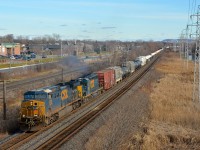 <b>Matching CSXT paint schemes.</b> CN 327 has AC4400CW CSXT 5120 & SD40-3 CSXT 4025, both in the same paint scheme, as it heads through Pointe-Claire with 89 cars in tow.