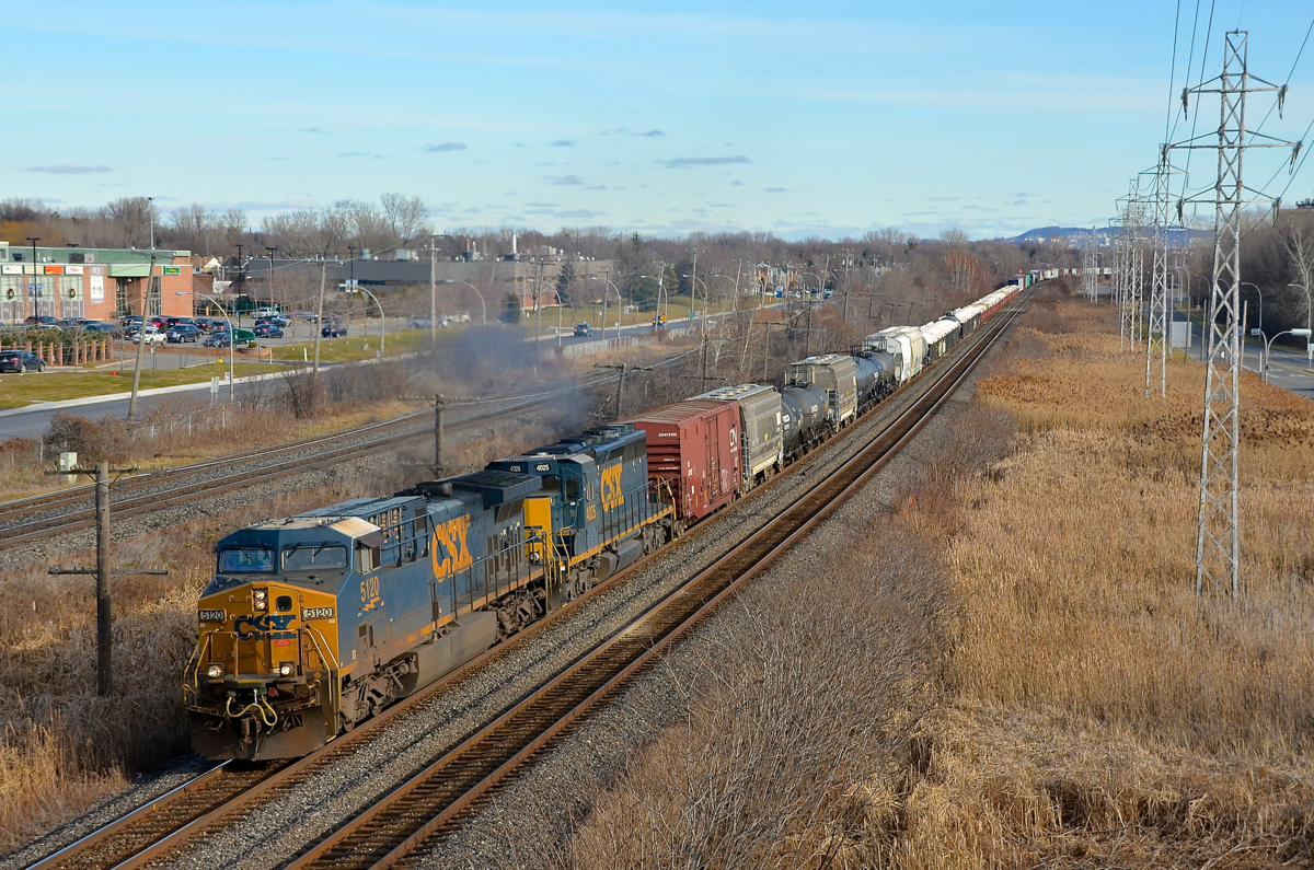 Matching CSXT paint schemes. CN 327 has AC4400CW CSXT 5120 & SD40-3 CSXT 4025, both in the same paint scheme, as it heads through Pointe-Claire with 89 cars in tow.