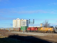 <b>A single well car up front.</b> CP 142 is through Dorval with a single well car up front (and more further back) as well as a UP leader, with ES44AC's UP 5532 & CP 8954 for power.