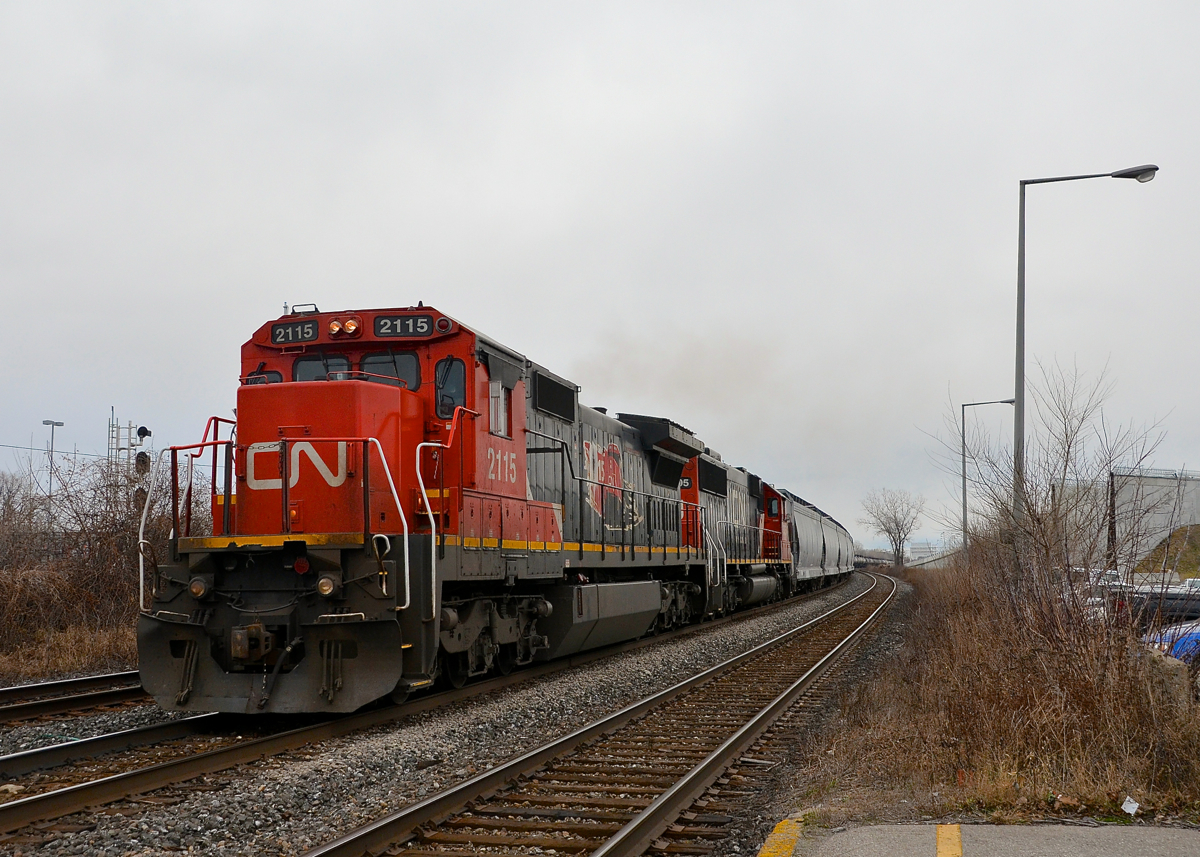 While through freights on CN's Montreal-Toronto corridor are mostly the domain of boring ES44AC's these days, once in awhile a stellar lashup appears. Witness CN 377 with 15th anniversary unit CN 2115 & ex-Oakway CN 5405 heading west through Dorval on a grey afternoon.