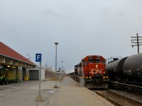 <b>Sparks are flying.</b> Sparks are flying as CN 586 passes through the VIA Dorval station on the south track with GP38-2 CN 4707 & GP38-2W CN 4802 for power as CN 377 passes at right on the north track.
