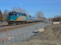 <b>A brand new right of way.</b> VIA 65 is westbound through the St-Henri neighbourhoood of Montreal on a brand new roadbed and brand new tracks. Until just a couple of weeks ago CN's Montreal sub was located on the now mostly empty space at right (note the ties piled up in the distance). Infrastructure projects in the Turcot area have made it necessary for CN to move their main line a bit further north. The train is approaching the De Courcelle crossing, which reopened to vehicular traffic two days ago after being closed for about 4-5 months.