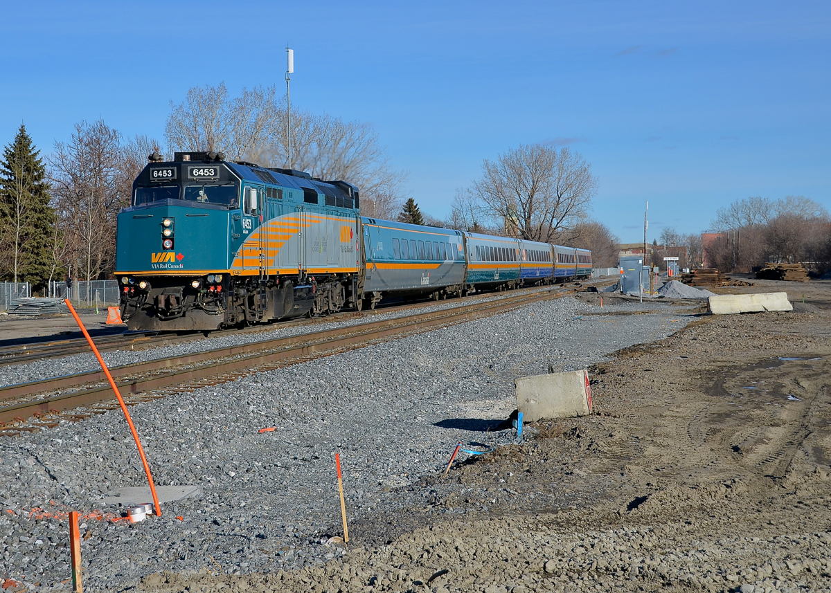 A brand new right of way. VIA 65 is westbound through the St-Henri neighbourhoood of Montreal on a brand new roadbed and brand new tracks. Until just a couple of weeks ago CN's Montreal sub was located on the now mostly empty space at right (note the ties piled up in the distance). Infrastructure projects in the Turcot area have made it necessary for CN to move their main line a bit further north. The train is approaching the De Courcelle crossing, which reopened to vehicular traffic two days ago after being closed for about 4-5 months.