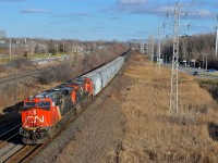 <b>Snow? What snow!</b> CN 2874 & CN 2802 lead CN 377 west through Pointe-Claire on a bright but snowless winter afternoon.