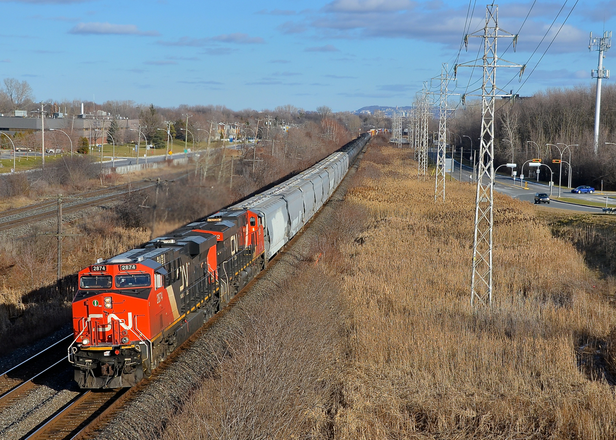 Snow? What snow! CN 2874 & CN 2802 lead CN 377 west through Pointe-Claire on a bright but snowless winter afternoon.