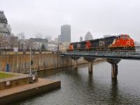 <b>A foggy morning.</b> CN 149 is crossing the Lachine Canal in Montreal with a pair of ES44AC's (CN 2932 & CN 2930) on a very foggy morning.