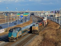 <b>A rare VIA/KCS meet.</b> With Kansas City Southern not operating anywhere near routes used by VIA Rail, it's not everyday you see a KCS engine meeting a VIA one. Here CN 529 with two KCS engines up front (KCS 4610 & KCS 4147, with NS 6923 last) is stopped as VIA 55 passes it, led by VIA 6455. CN 529 originates on Norfolk Southern tracks as NS 31T and becomes CP 931 when interchanged to CP. CN picks it up at Rouses Point where it becomes CN 529.