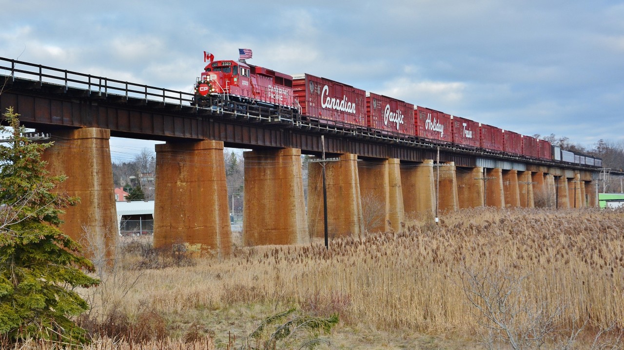 he CPR  Christmas Train 2015 version ( a k a the Canadian Pacific Holiday Train ) CP #2323 West  rolls across the Ganaraska Viaduct built circa 1912.  Business car Van Horne handling the FRED.
 

 CP#2323 West reportedly encountered three eastbounds at Brighton, Colbourne and Spicer: An ethanol, tank (lead by UP) #142 and double-stack #112 hence #2323 west operating appropriately thirty minutes late with a scheduled 15:00  Bowmanville arrival and the thirty minute stage performance scheduled at 15:15
 

The CPR Holiday Train U.S.  Version passed through Port Hope earlier in the day, about 09:15, enroute to Hamilton.
 

14:58 November 30, 2015 image at Port Hope by S.Danko