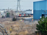  CN 7046 – CN 4116  are deep into the Gerdau Ameristeel property to retrieve eleven loads.
<br>
<br>
Mile 304 Kingston Subdivision, Hopkins Street overpass, Whitby, Ontario, 
<br>
<br>
December 9, 2015 image by S.Danko.
<br>
<br>
More working CN Geep's :
 <br>
<br>
        <a href="http://www.railpictures.ca/?attachment_id=11619">  Ganaraska River </a> 
 <br>
<br>
<a href="http://www.railpictures.ca/?attachment_id=11617">  behind the station </a> 
 <br>
<br>
More Hopkins Street bridge: 
 <br>
<br>
<a href="http://www.railpictures.ca/?attachment_id=8659">   different decade </a> 
 <br>
<br>
<a href="http://www.railpictures.ca/?attachment_id=13252">  single unit </a> 
 <br>
<br>
sdfourty