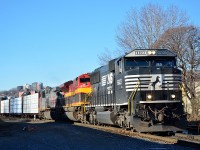 CN 528, mixed freight from Montreal's Taschereau Yard to Enola PA, pulls across St Ambroise Street on a sunny Boxing Day morning.