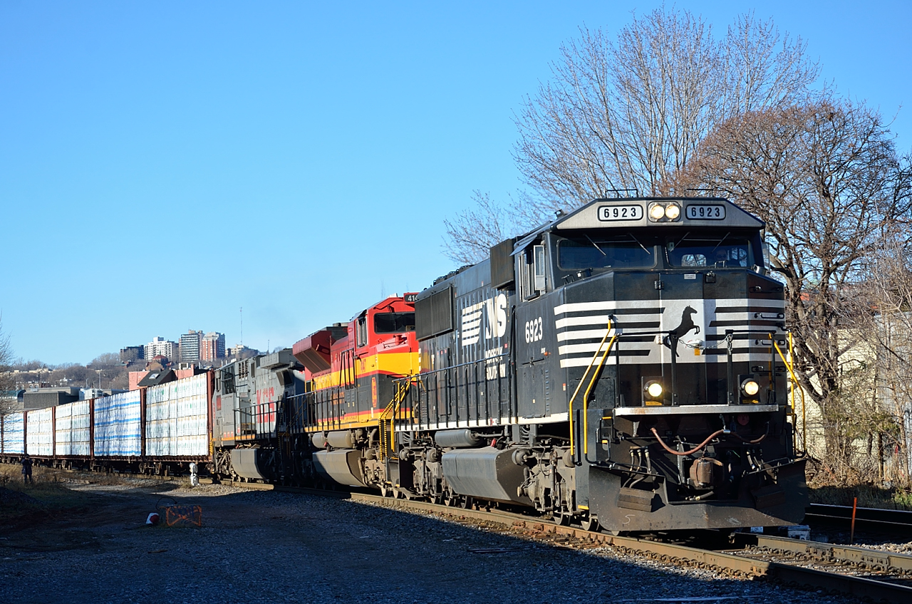 CN 528, mixed freight from Montreal's Taschereau Yard to Enola PA, pulls across St Ambroise Street on a sunny Boxing Day morning.
