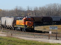 It amazes this photographer how American Class 1 railways still have small operations toiling away on isolated rails far from their own mainlines. The BNSF has one such example, and it exists within the confines of Manitoba's capital. Now known as Burlington Northern Santa Fe (Manitoba), more commonly referred to as the BNML (Burlington Northern Manitoba Ltd. -given to it after the merger between Burlington Northern and Great Northern Railroads in 1971).<br> I know little of the operation, but they own little trackage and serve only a few customers, with their traffic being forward by CN to BNSF in Noyes, Minnesota. This day the crew in BNSF GP39-3 2694 hauls a long transfer (50ish? cars) around the curve at Portage Jct. and into CN's Fort Rouge yard. After setting off their drag, they would couple onto a dozen cars for the short return trip to home rails. I would like to hear some comments from anyone more knowledgeable about the operation. 