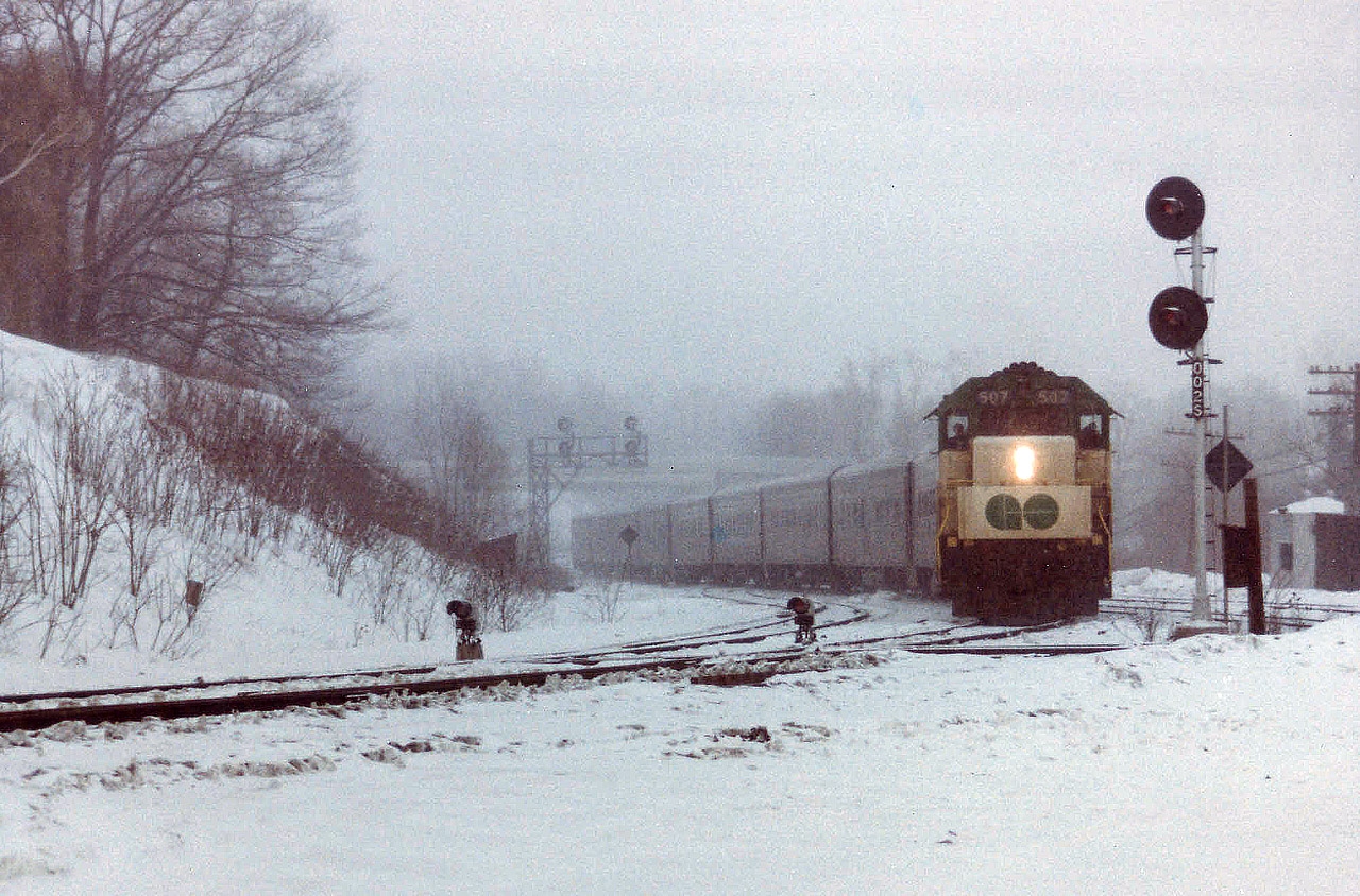 An all-day miserable snowstorm, much more frequent then than now; sets the scene for this image taken from the former railfan parking area at Bayview Junction. Perhaps this inclement weather is the reason GO 507, (GP40TC) is subbing for the usual CN tempo engine this time around. There are the standard 8 cars in tow. The 507, originally 607 when it joined on with GO Transit in 1966, went to Amtrak in 1988 as their 199.