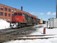 As a contrast to Bill Thomson's excellent photo of VIA 83 at Brampton diamond <a href=http://www.railpictures.ca/?attachment_id=22078><b>*here*</b></a>, here's a more modern view of the same spot: CN freight #385 heads westbound through town, with GE C44-9W's IC 2726 and CN 2690 about to start hammering the diamond on the north track of the Halton Sub. The former CP line in the foreground now belongs to the Orangeville Brampton Railway (as the OBRY Owen Sound Spur) and sees use only twice a week. At the time, CP was still sending maintenance crews to regrind the diamonds from wear every so often, and CP trucks parked around the diamond area was a common occurrence.