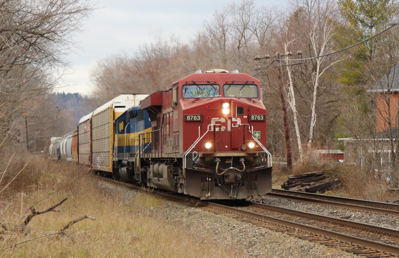 CP 8763 leads ICE 6212 (City of Buffalo) around the bend and up to the Martin Street crossing in Milton with a mixed manifest of freight and autoracks.