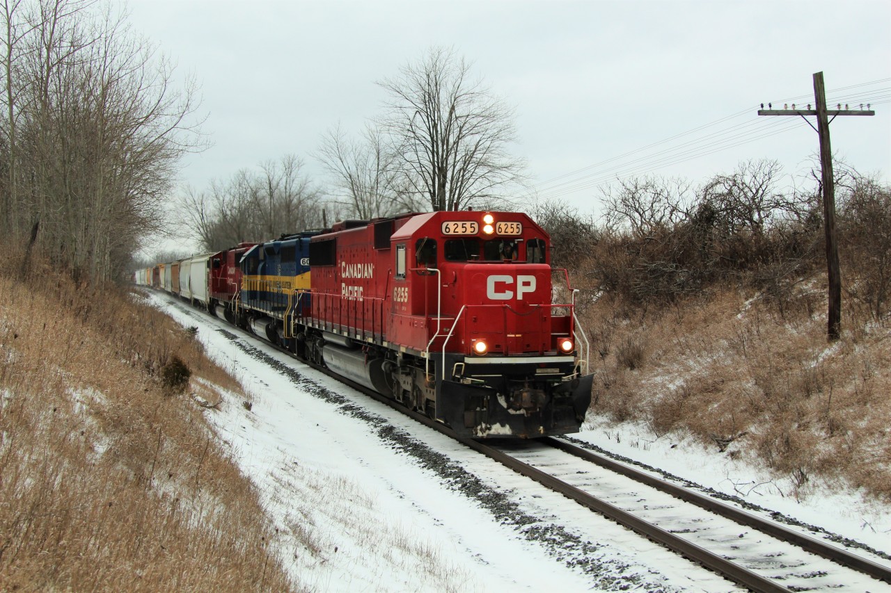 On the last day of the year, CP sent an ex-SOO sandwich. Leading is CP 6255 (GMD SD60) followed by DME 6090 (City of Phillip) and CP 6262 (GMD SD60M) on their way to Guelph Junction approaching MM43 on the Galt sub. 
The CTG says ex-SOO 6262 is a one of a kind. Sure would have been nice to see this leading.