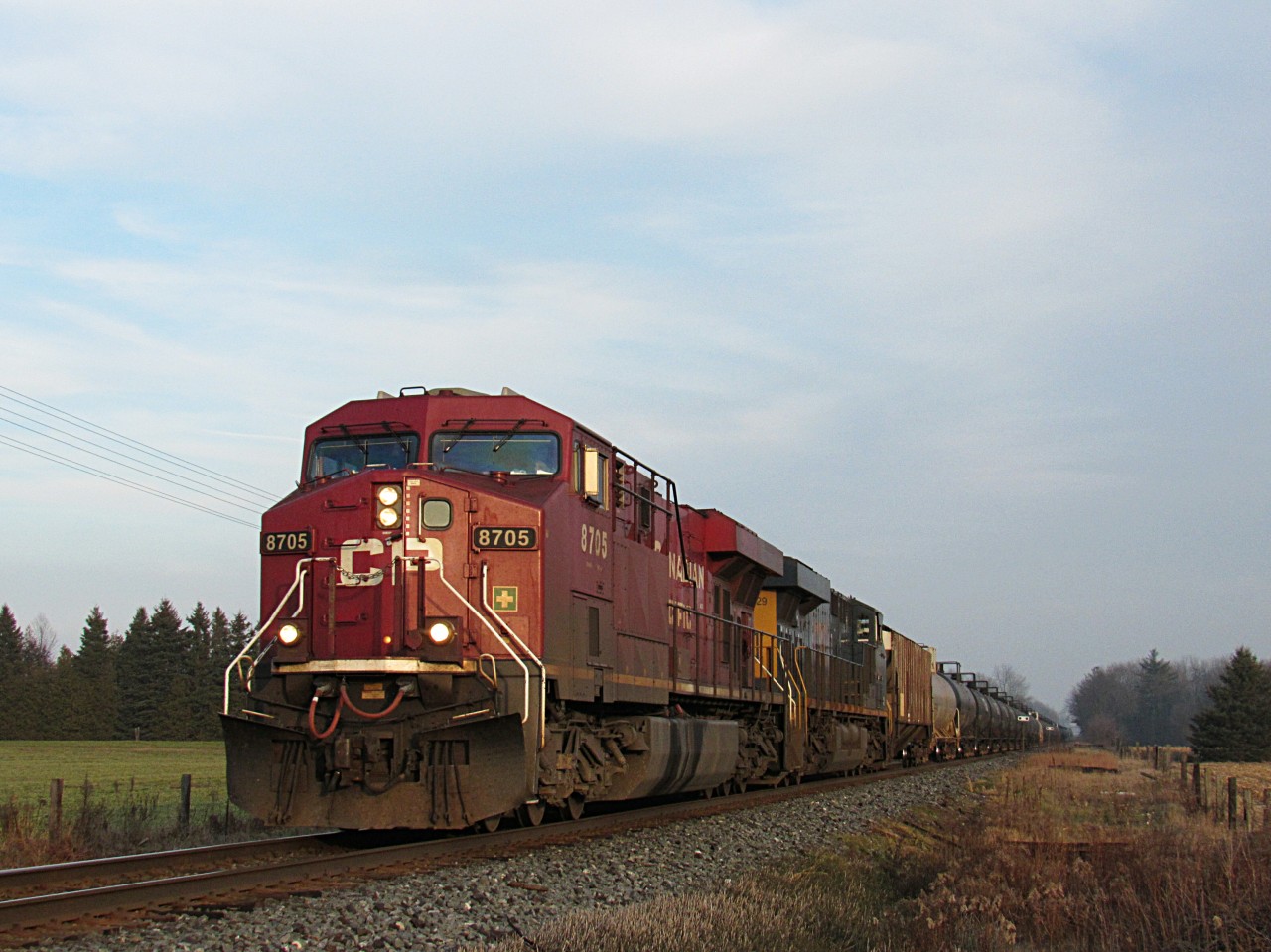 Ever had to chase high ballin oil cans from Hamilton to practically Woodstock because of your scanner? If so, you may relate to this story... CP 8705 was cleared north on the Hamilton Sub out of Kinnear. Didn't hear it because the transmission was muffled, so I assumed it was a yard job or 255 or 247. But thanks to a Facebook post, it was empty CP oil train, 647 with CSX 3028 trailing. After 246 showed up at 6 in the morning with a UP, amd in the dark, this was our only foreign power for the day. We drove all the way from CN Snake, to Ayr, Ontario to catch up to 647 and see it. We arrived in Ayr, and it was still a while away (so I thought). So,we headed east to Orr's Lake siding. Missed it. Then drove to Wolverton, but it would of been too close. So, we decided to go to Blandford Siding where we finally caught it.