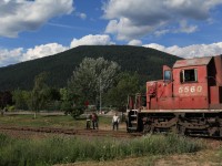 A timeless scene with a local looking on. The weed train is being put away for the night in Curzon, BC.