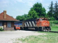 This image is "pre-VIA" as we know it.  In 1977, VIA was but an extension of CN, formed in 1976. The passenger business spun off; separate identity under the CN banner,  hence the CN leader 9509 and the trailing steam generator car already in that familiar VIA paint scheme. The national passenger system as we know it did not materialize until 1978. The old Paris station stood for a few more years, not sure when it was demolished, but it served as amaintenance storage building for quite a long while.