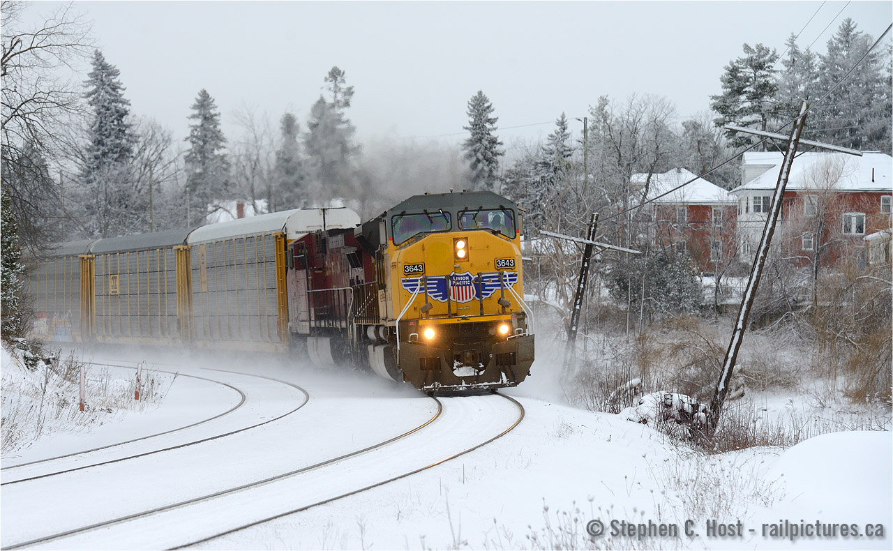 With a splash of yellow and red on an otherwise grey day, UP 3643 east is finally on the move after a hotbox setoff at Guelph Junction.