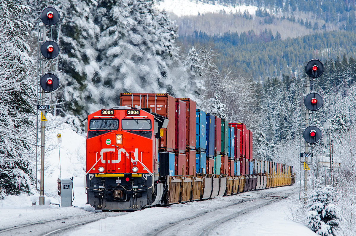 CN ET44AC 3004 gets Q199's train up to speed in a hurry after a crew change 2.6 miles behind at Jasper. They've just taken the signal at Wynd on CN's Albreda Sub.