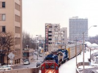 
A rather interesting CP #523 snakes thru downtown Hamilton past the Art Deco-style TH&B station in this image taken from overhead where the line goes thru Hunter St. tunnel.  Nice power set: CP 5752, CRL 0608, SOO 6608 and CR 5299. (The CRL is Conrail Leasing, an arm of the CR system)  Note the area being readied for increased GO service; trainset staging area under construction as well as the old station restoration, evident by all the scaffolding on the left side of the building in this view.